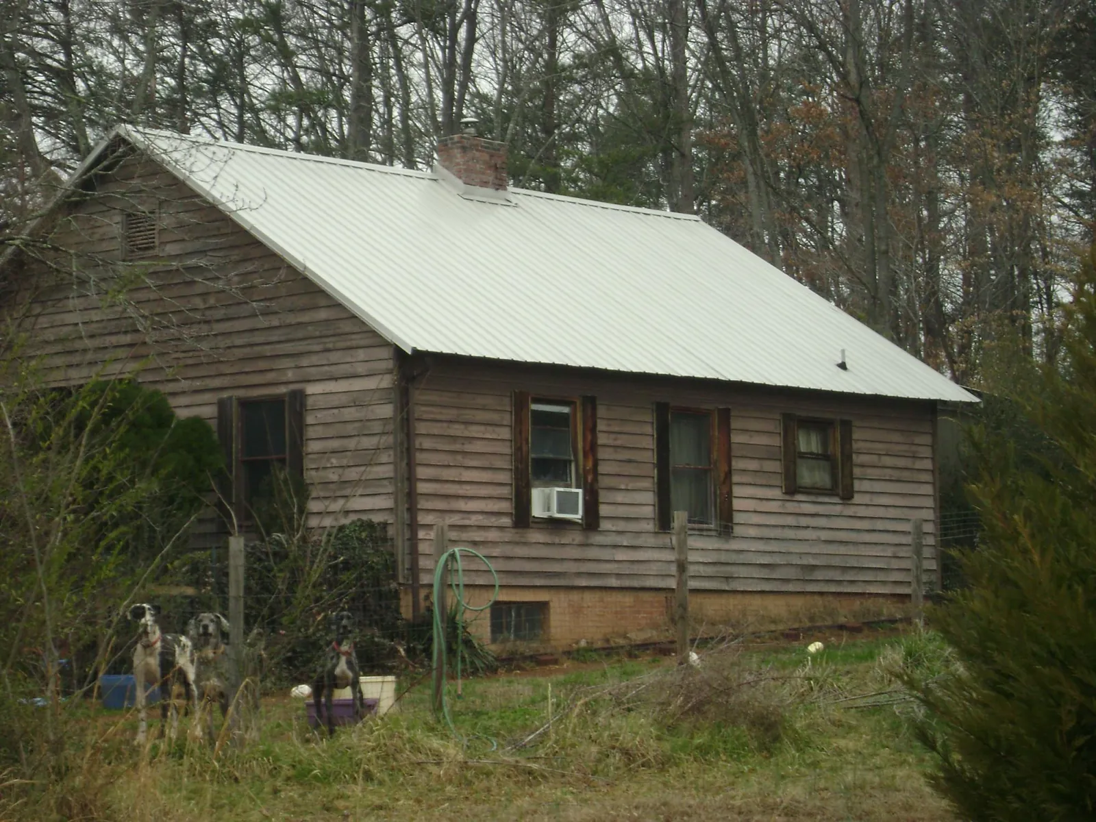White metal roof on an old wood sided farmhouse, from a Metal Roof Installation job in Farmington